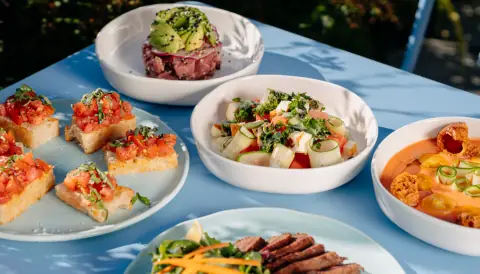 A spread of colorful dishes on Tonique’s blue terrace table